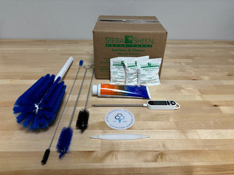photo of Brushes, Sanitizer, Lubricant, Thermometer, & O-ring Tool on a wood table