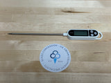 photo of thermometer on a wood table with slices concession sticker logo on the table