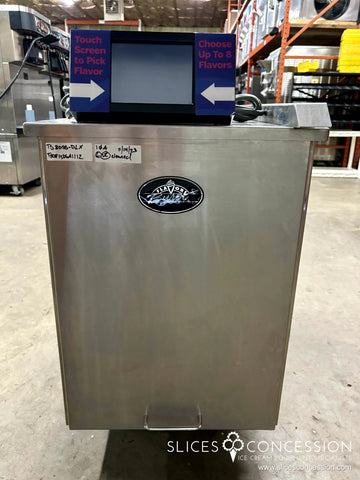 a photo of a Flavor Burst TS 80SS-DLX Striped Soft Serve Syrup Flavor System with touchpad on top and ice cream machines in the background
